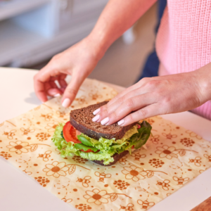 Sandwich being wrapped in beeswax wrap